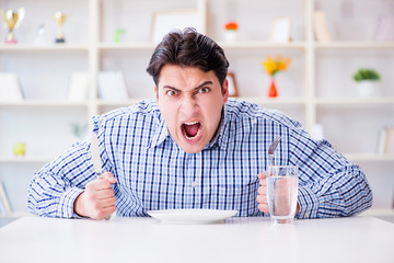 Man on diet waiting for food in restaurant