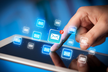 Fingers touching tablet with mail