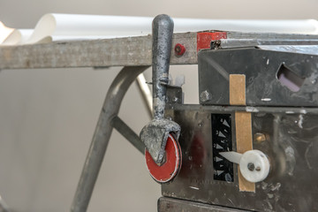 Renovation or refurbishment. Preparation of wallpaper with glue with a construction tools glue...