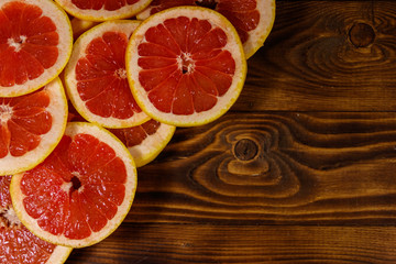 Sliced grapefruits on wooden table. Top view, copy space