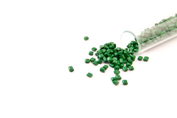 Plastic pallets . Plastic raw materials in granules for industry. Polymeric dye is green on a white background. Plastic granules after processing of waste polyethylene and polypropylene.Polymer.