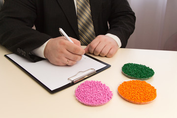 Businessman signs a contract for the supply of plastic granules for industry. Plastic raw material...