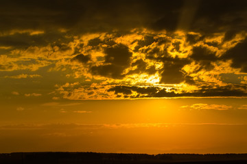 Last rays of setting sun painted sky in yellow and orange colors.