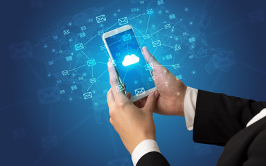 Hand using smartphone with message icons