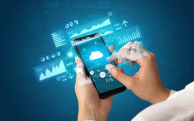 Hand using phone with financial tracking concept