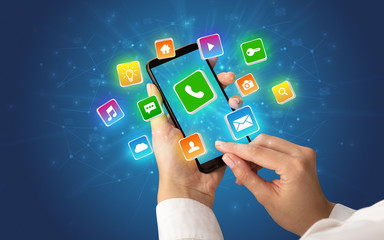 Hand using phone with shiny application icons