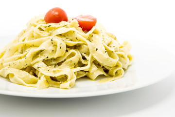 Pasta with pesto sauce and nuts on a the table