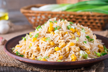 Homemade Chinese fried rice with vegetables and fried eggs on a plate (Selective Focus)