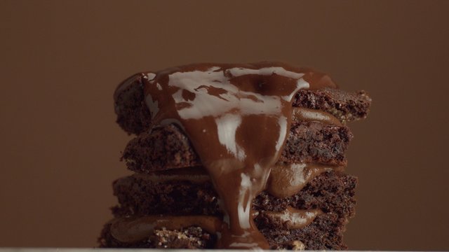 chocolate cake with chocolte cream with different texture. with liquid chocolate pouring on it