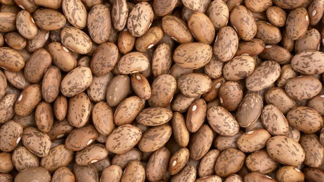 Raw pinto beans closeup macro revolving on a turntable. Overhead view. Not loopable. Colors out of camera. No color grading.