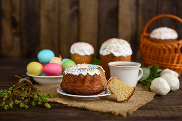 Easter cake and colorful eggs on a wooden table. It can be used as a background