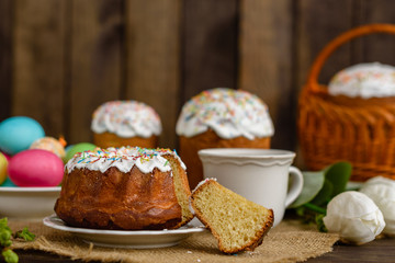 Easter cake and colorful eggs on a wooden table. It can be used as a background