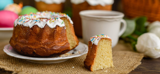 Easter cake and colorful eggs on a wooden table. It can be used as a background