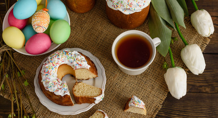 Easter cake and colorful eggs on a wooden table. It can be used as a background