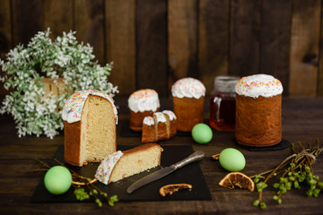 Easter cake and colorful eggs on a wooden table. It can be used as a background