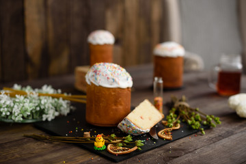 Easter cake and colorful eggs on a wooden table. It can be used as a background