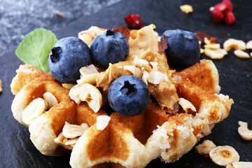 Belgian waffles with pomegranate and raspberries, homemade healthy breakfast with mint