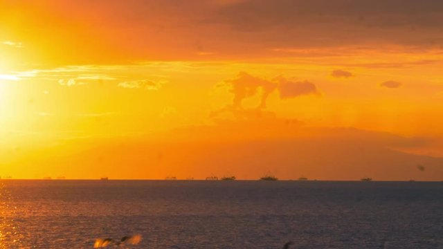 4k Time lapse of Manila bay sunset, with ships passing on horizon