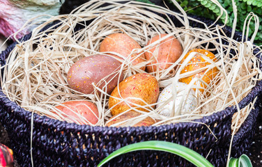 large spotty eggs lying in basket filled with straw