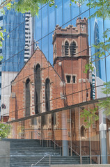 Beautiful reflection of old St. Georges Cathedral in the front of a modern office building, Perth, Western Australia