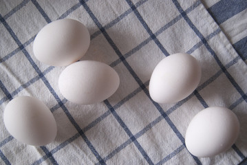 Eggs on a white tablecloth with a geometric pattern