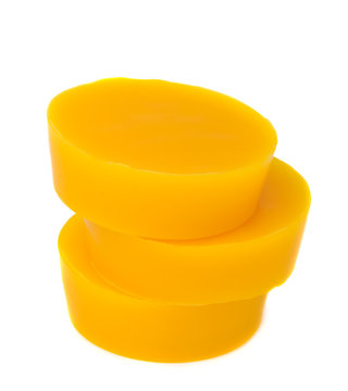 Pieces of natural beeswax are isolated on a white background. Beekeeping products. Apitherapy.