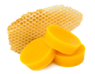 Pieces of natural beeswax and a piece of honey cell are isolated on a white background. Beekeeping...