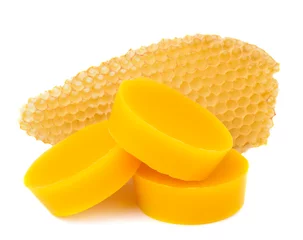 Fotobehang Pieces of natural beeswax and a piece of honey cell are isolated on a white background. Beekeeping products. Apitherapy. © kosolovskyy
