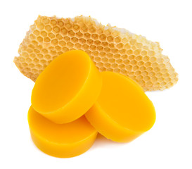 Pieces of natural beeswax and a piece of honey cell are isolated on a white background. Beekeeping...