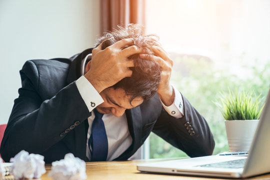 Asian businessman man depressed because he was in trouble in the business he is handle in progress.