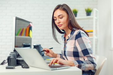 pretty young woman photographer with camera in office - Powered by Adobe