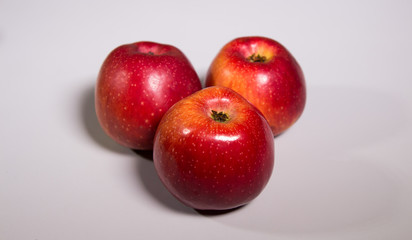 Three red apples with shadow