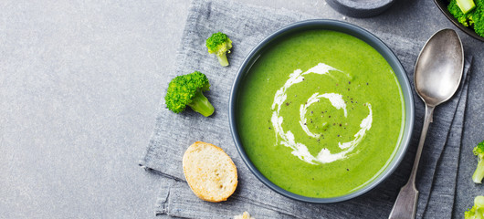 Broccoli cream soup in a bowl with toasted bread. Top view. Copy space.