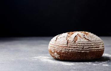 Bread rye, whole grain on a grey slate background. Copy space.