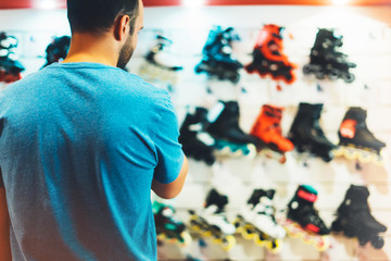 Assortment roller skates isolated in store shop, person choosing and buy color roller-skates on...