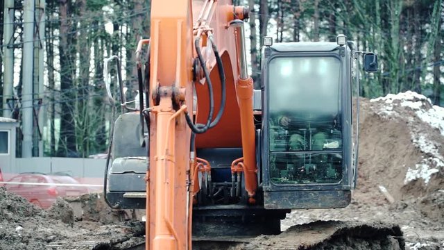 Loader backhoe, excavator digging a trench. Clip. Work of excavating machine on building construction site. Excavator digs a hole