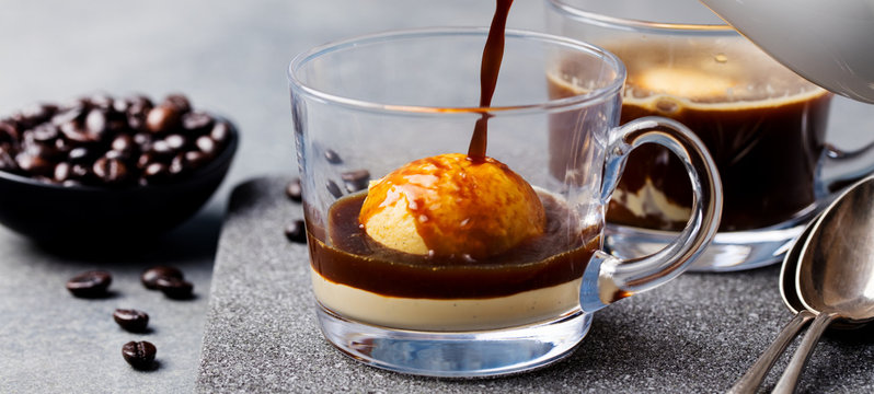 Affogato coffee with ice cream on a glass cup. Grey slate background.