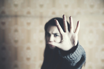 woman hand stop sign in background