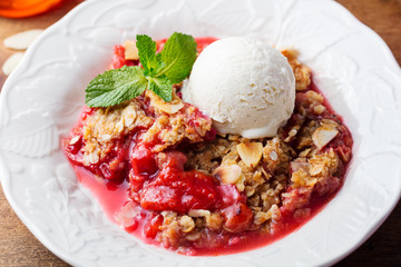 Crumble with berries and fruits with vanilla ice cream.