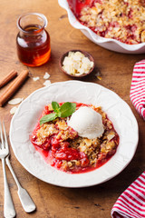 Crumble with berries and fruits with vanilla ice cream.