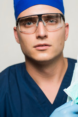 young surgeon on white background