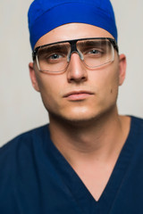 young surgeon on white background