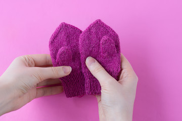 Woman is holding children's mittens