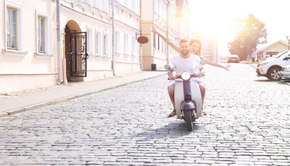Happy young couple having fun on a scooter © ASDF