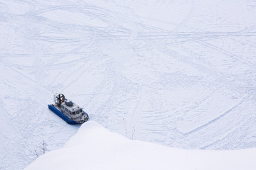 Hovercraft transporter on the ice of river in winter day, The view from the top