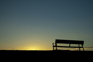 Fototapeta na wymiar Silhouette chair on Sunset background.
