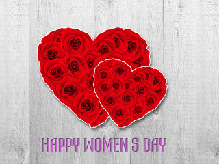     Women's day card. Tulip flower small hearts on white wooden background. 

