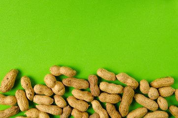 Peanuts on a bright green background.