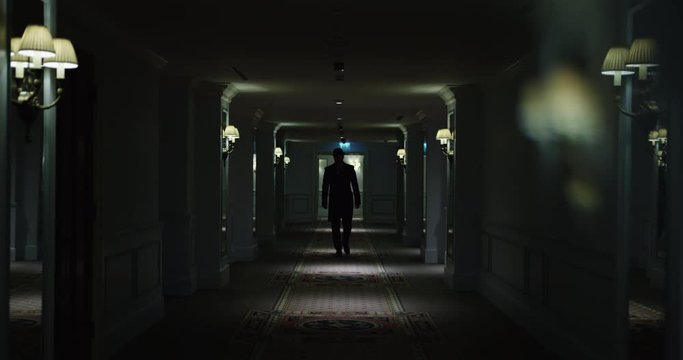 Man going in dark corridor