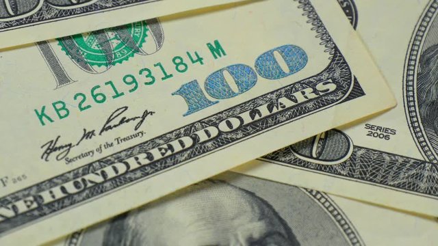 Hundred-dollar bills close-up, motion slider - 8. Macro photography of banknotes. Portrait of Benjamin Franklin.